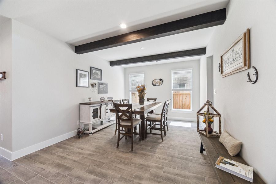 Bright dining area with tile, exposed ceiling beams, and abundant natural light. Bright dining area with tile, exposed ceiling beams, and abundant natural light.