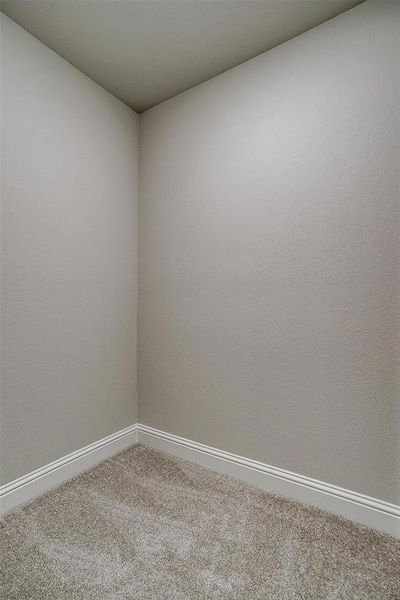 Empty room featuring carpet floors and baseboards