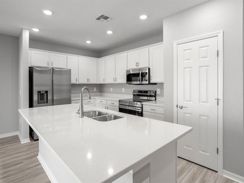 Your island kitchen includes 36-inch cabinets, quartz countertops, Samsung SS appliances, and a pantry.