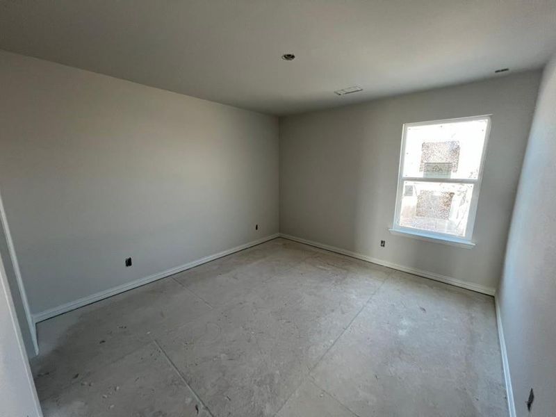 Spare room featuring baseboards