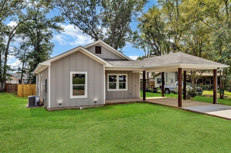 View of front facade featuring board and batten siding, an attached carport, concrete driveway, and roof with shingles View of front facade featuring board and batten siding, an attached carport, concrete driveway, and roof with shingles