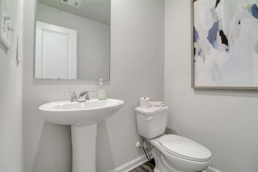 A bathroom with a toilet and sink.