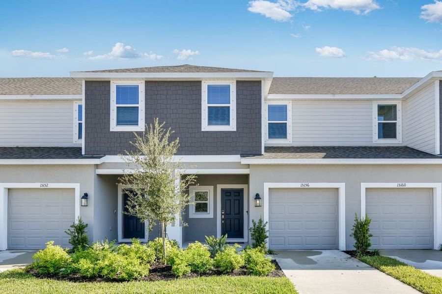 Front exterior of a new home in Vinterra Townhomes, Nokomis, FL, highlighting curb appeal (Image 1).