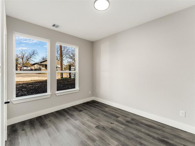 Empty room with dark wood-type flooring