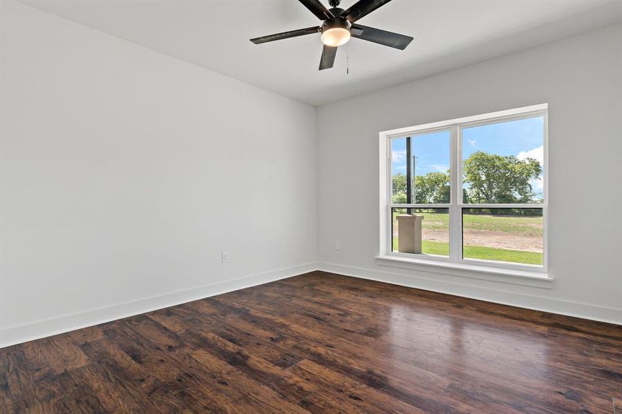 Spare room with ceiling fan and wood-type flooring