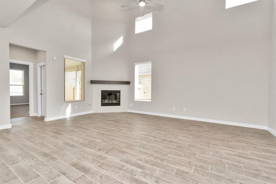 Take another glimpse into the heart of the home with this additional view of the family room—a sprawling space ready to accommodate all your gatherings. Sample photo of completed home with similar floor plan. As-built interior colors and selections may vary.