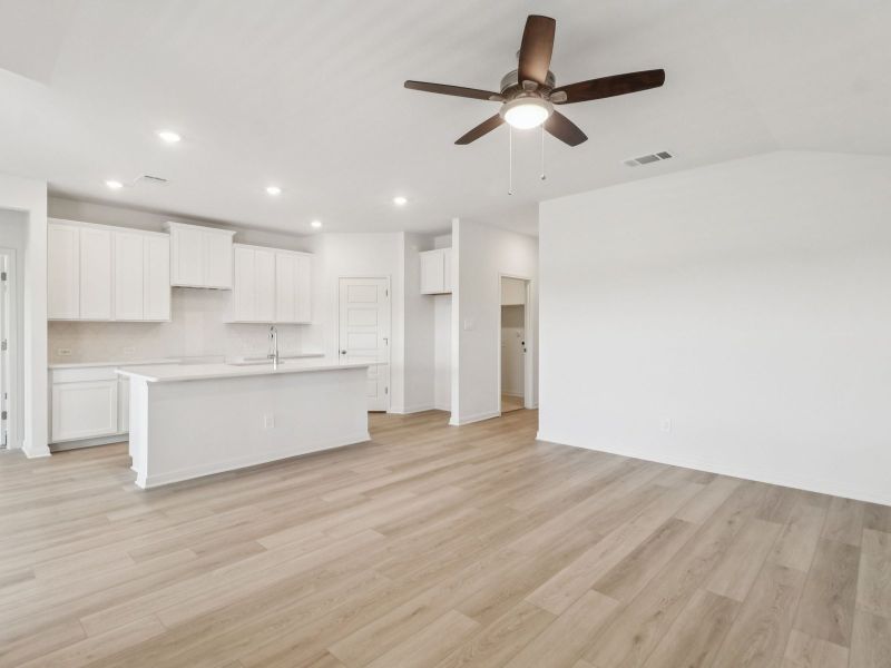 Living room and kitchen in the Callaghan floorplan at a Meritage Homes community. Living room and kitchen in the Callaghan floorplan at a Meritage Homes community.