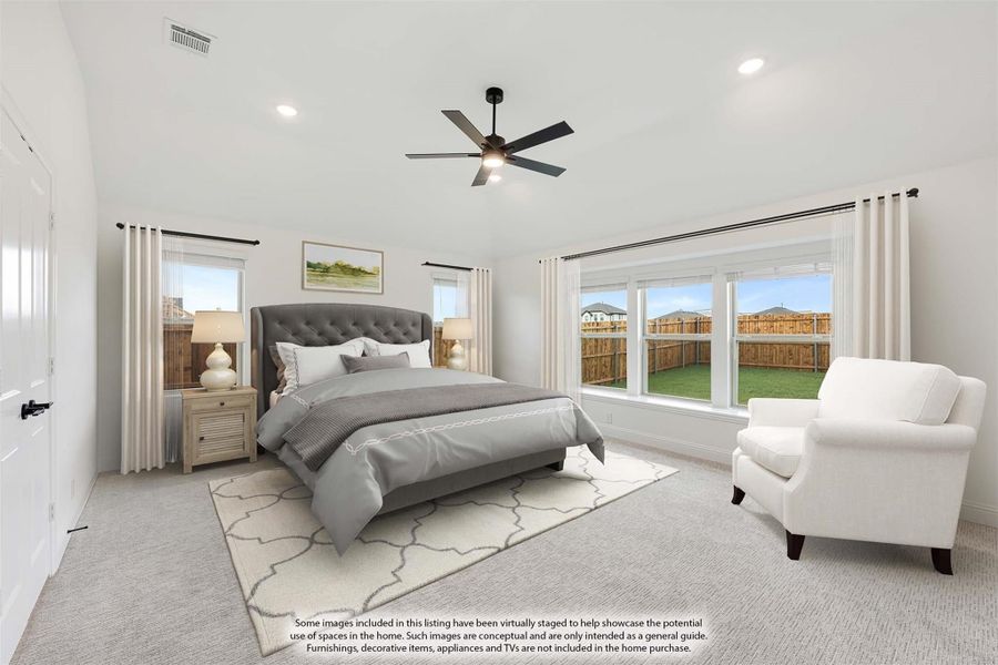 Spacious master bedroom with ceiling fan, large windows, carpet flooring, and a sitting area with white armchair Spacious master bedroom with ceiling fan, large windows, carpet flooring, and a sitting area with white armchair
