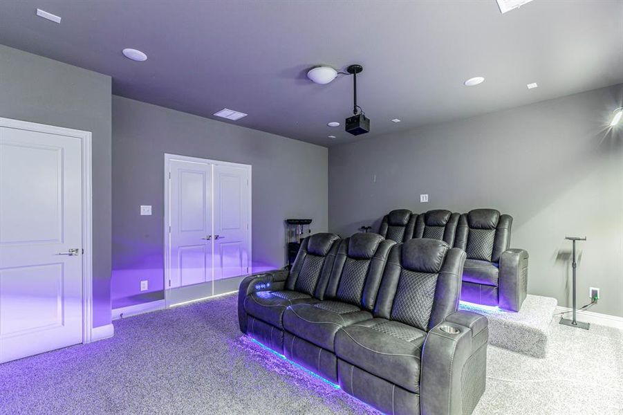 Cinema featuring light colored carpet and recessed lighting Cinema featuring light colored carpet and recessed lighting