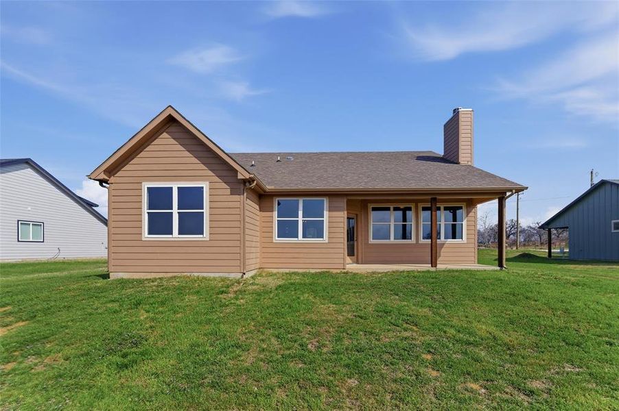 Straight-on view of the backyard and rear of the home. Straight-on view of the backyard and rear of the home.