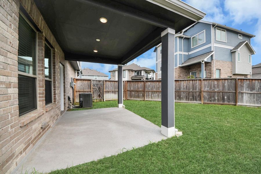 Exterior details and patio area of a home in The Groves, Humble (Image 29).