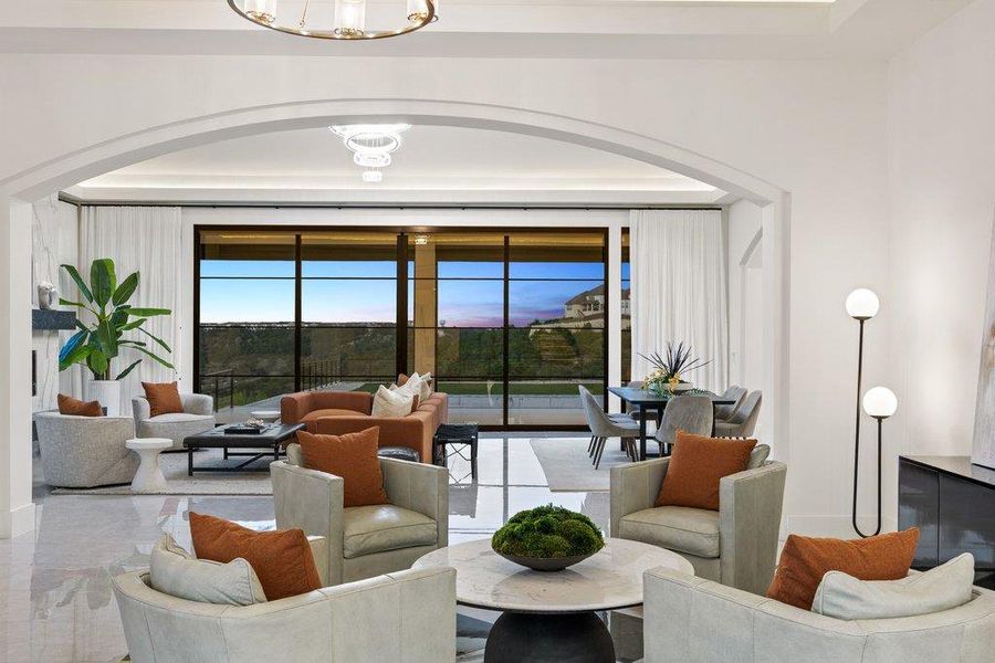 An open-concept living area with soaring ceilings and expansive windows offers breathtaking scenic views.