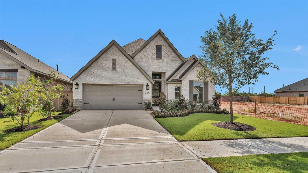 Front exterior of a new home in Grange 50', Katy, TX, highlighting curb appeal (Image 2). Front exterior of a new home in Grange 50', Katy, TX, highlighting curb appeal (Image 2).
