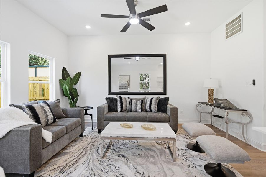 Open concept kitchen, dining and living room, with lots of natural light.