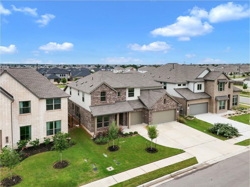A neighborhood vista showcasing well-maintained homes with manicured lawns and spacious driveways.