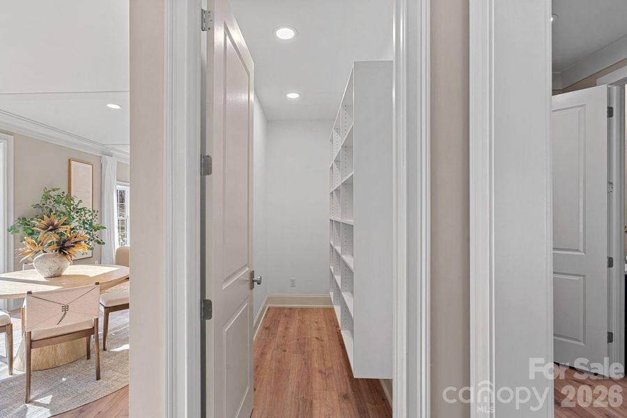 Custom walk-in pantry with solid shelving and future-ready plumbing and power for a Robot—where smart design meets maximum storage.