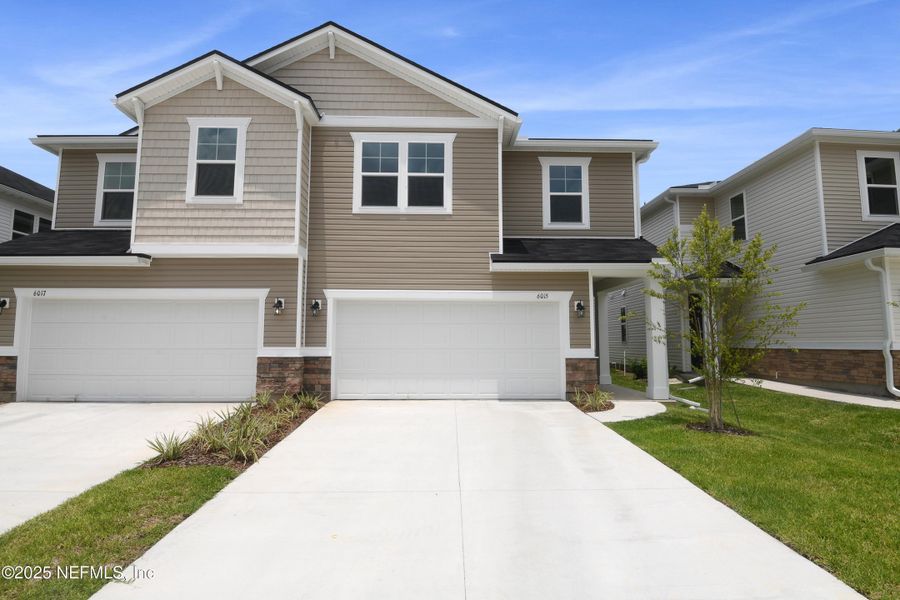 Front exterior of a new home in Seasons at Park Trace, Jacksonville, FL, highlighting curb appeal (Image 17).