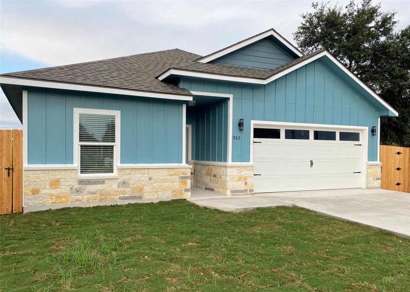 A newly constructed residence showcasing modern blue siding and an attached garage.