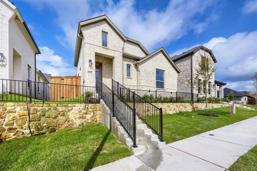 Stone-faced retaining wall enhancing a graded front yard Stone-faced retaining wall enhancing a graded front yard