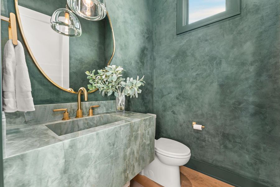 Half bathroom featuring vanity and wood finished floors Half bathroom featuring vanity and wood finished floors