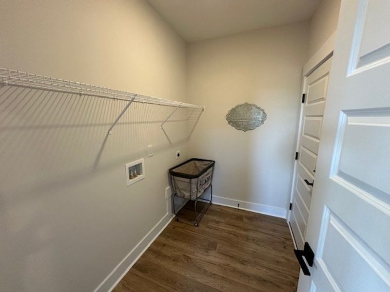 This dedicated laundry space features ample shelvi