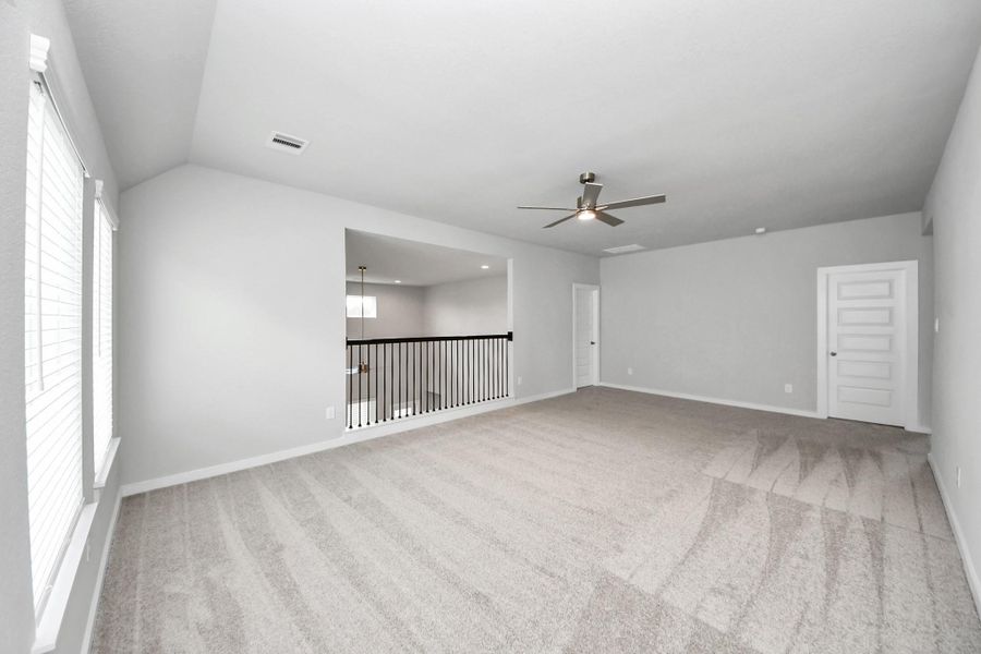 Come upstairs and relish a day of relaxation in this loft area! Ideal as an additional living space or game room, it boasts plush carpeting, high ceilings, custom paint, and windows that flood the area with abundant natural light. Sample photo of completed home with similar floor plan. Actual colors and selections may vary. Come upstairs and relish a day of relaxation in this loft area! Ideal as an additional living space or game room, it boasts plush carpeting, high ceilings, custom paint, and windows that flood the area with abundant natural light. Sample photo of completed home with similar floor plan. Actual colors and selections may vary.