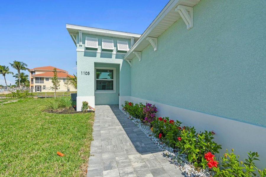 Front exterior of a new home in , Cape Coral, FL, highlighting curb appeal (Image 18). Front exterior of a new home in , Cape Coral, FL, highlighting curb appeal (Image 18).