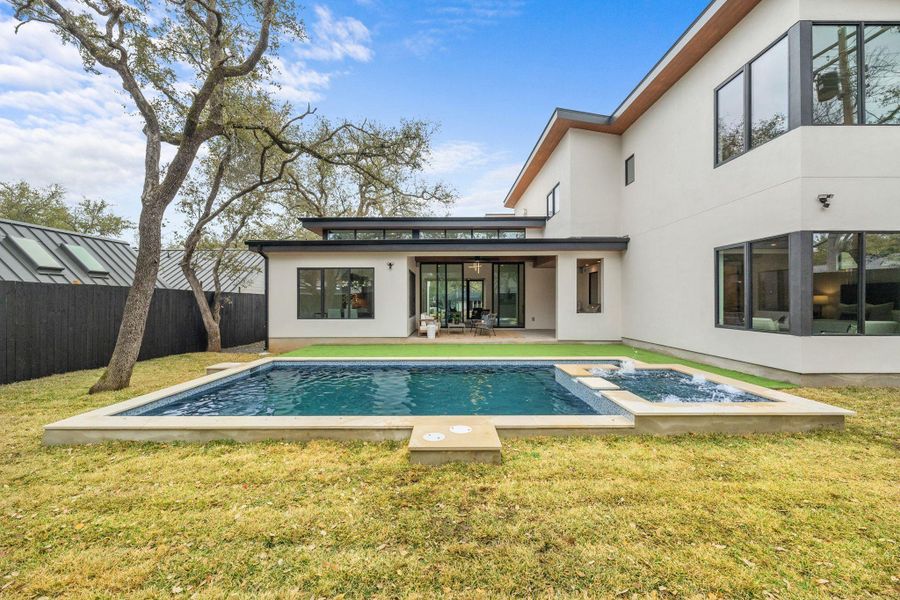 Rear view of house featuring stucco siding and a patio