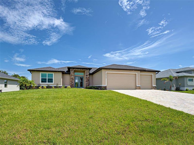 Front exterior of a new home in , Port Charlotte, FL, highlighting curb appeal (Image 1).
