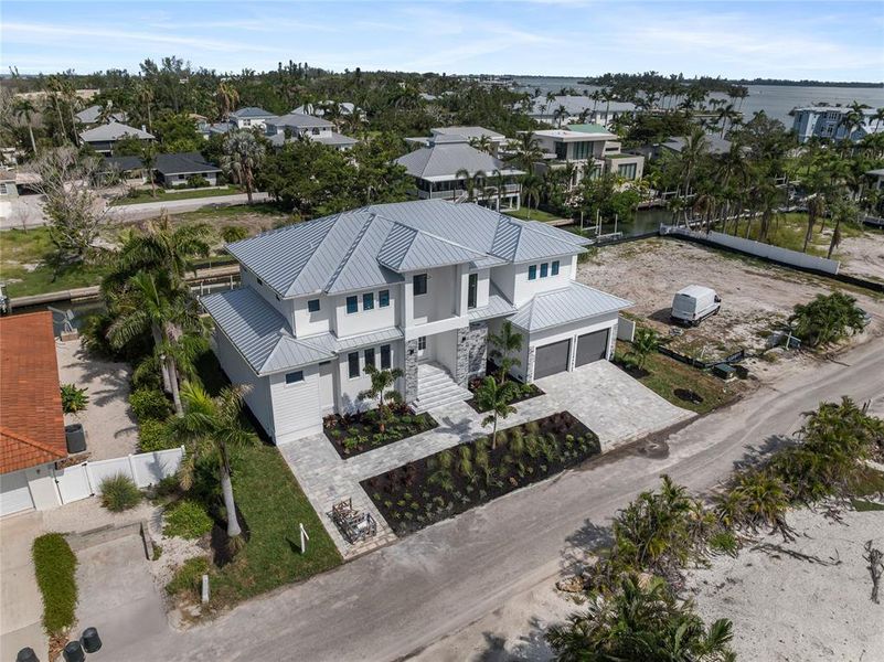 Front exterior of a new home in , Longboat Key, FL, highlighting curb appeal (Image 25). Front exterior of a new home in , Longboat Key, FL, highlighting curb appeal (Image 25).