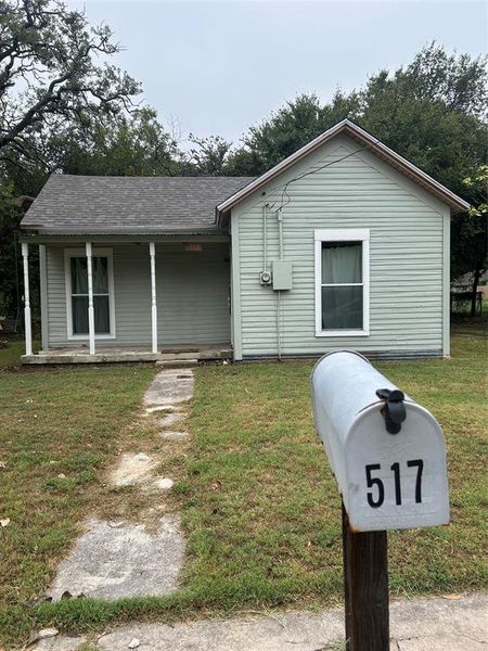 View of front of house with a porch, a front lawn, and a shingled roof View of front of house with a porch, a front lawn, and a shingled roof