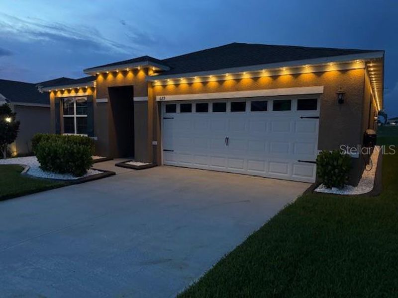 Front exterior of a new home in Eden Hills, Lake Alfred, FL, highlighting curb appeal (Image 28). Front exterior of a new home in Eden Hills, Lake Alfred, FL, highlighting curb appeal (Image 28).