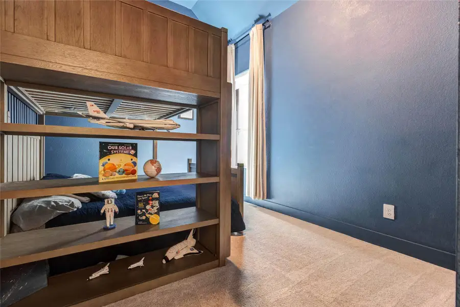 This bathroom features a modern design with a sleek vanity and black fixtures. It has a spacious shower with glass doors and stylish blue tiles, complemented by natural light from a window. This bathroom features a modern design with a sleek vanity and black fixtures. It has a spacious shower with glass doors and stylish blue tiles, complemented by natural light from a window.