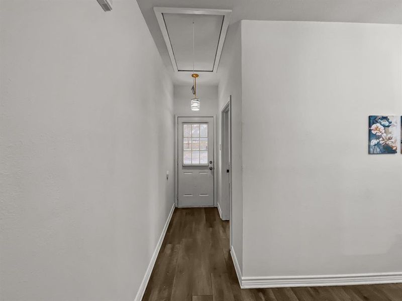 Entry hallway with dark wood-style floors