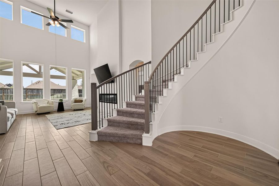 The dramatic staircase and open foyer create a stunning architectural focal point. The dramatic staircase and open foyer create a stunning architectural focal point.