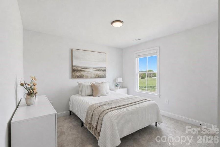 Bright secondary bedroom with plenty of natural light.