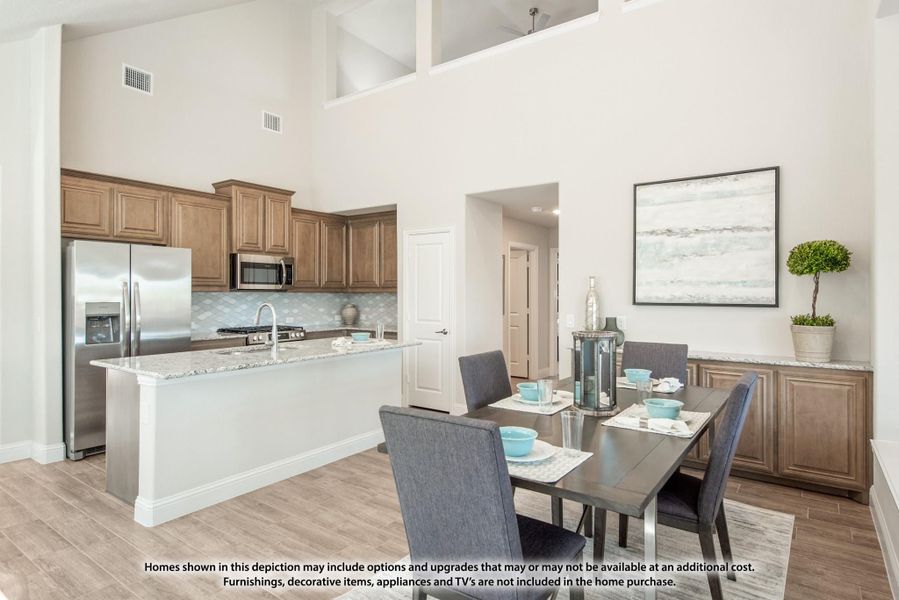 Open kitchen and dining area with granite island, wood cabinets, stainless appliances, and high ceilings Open kitchen and dining area with granite island, wood cabinets, stainless appliances, and high ceilings