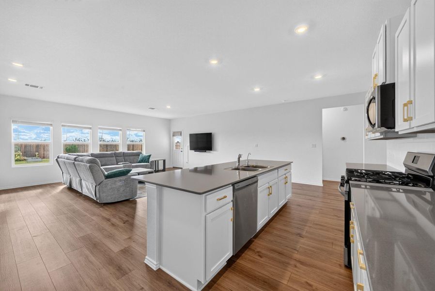 An open concept living area features ample natural light and seamless flow between kitchen and living spaces. An open concept living area features ample natural light and seamless flow between kitchen and living spaces.