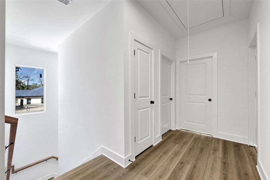 Bright hallway connecting the living space to upstairs bedrooms.