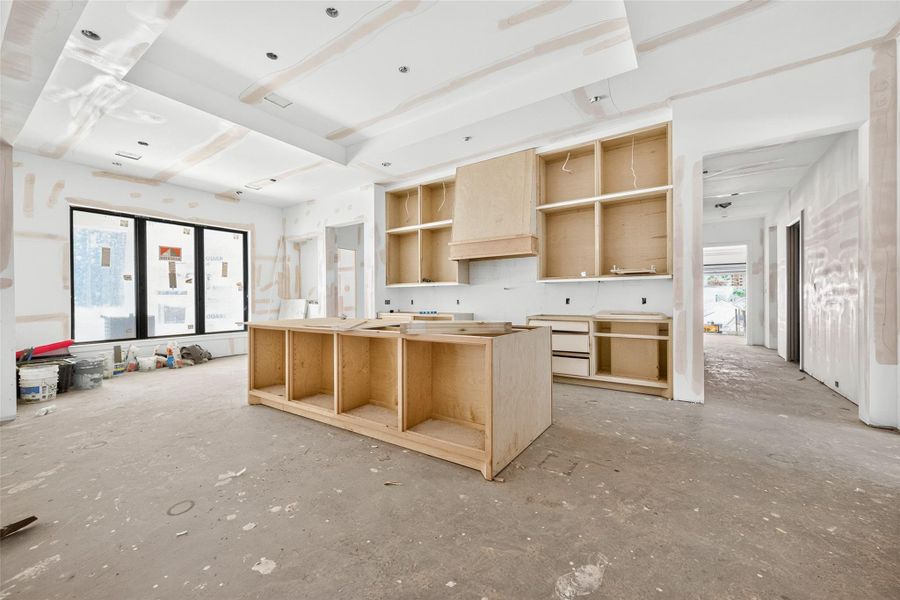 View of kitchen and breakfast nook. Waterfall island will feature stained alder with Cosentino sensa quartzite