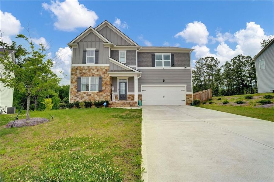 Front exterior of a new home in Thompson Ridge, Dallas, GA, highlighting curb appeal (Image 27). Front exterior of a new home in Thompson Ridge, Dallas, GA, highlighting curb appeal (Image 27).