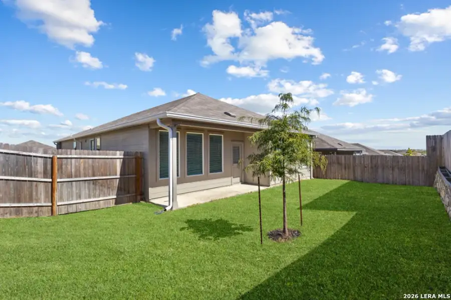 Exterior details and patio area of a home in Hightop Ridge, Converse (Image 28).