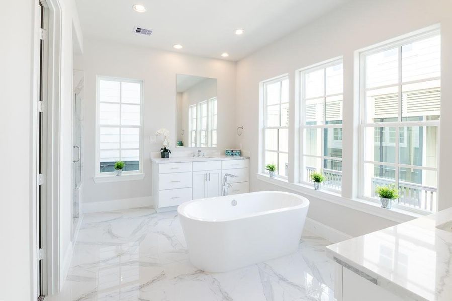 Bathed in glorious natural light and separate vanities.