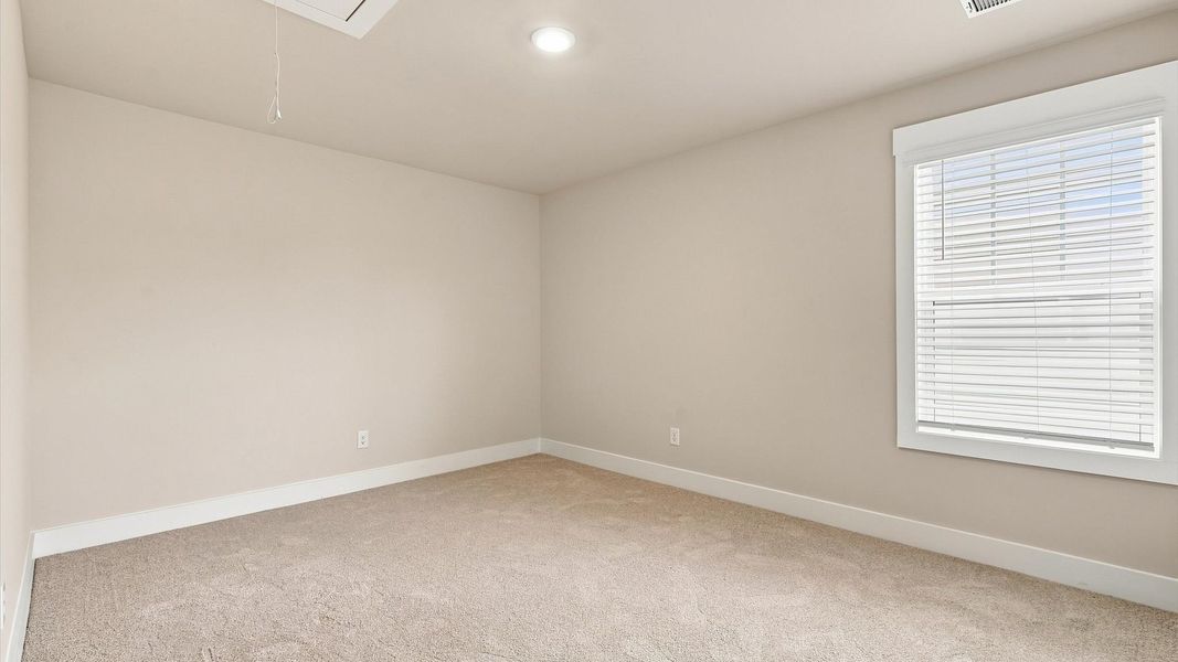 Vibrant and restful bedroom with an oversized window, refined detail, and a warm, welcoming atmosphere by DRB Homes