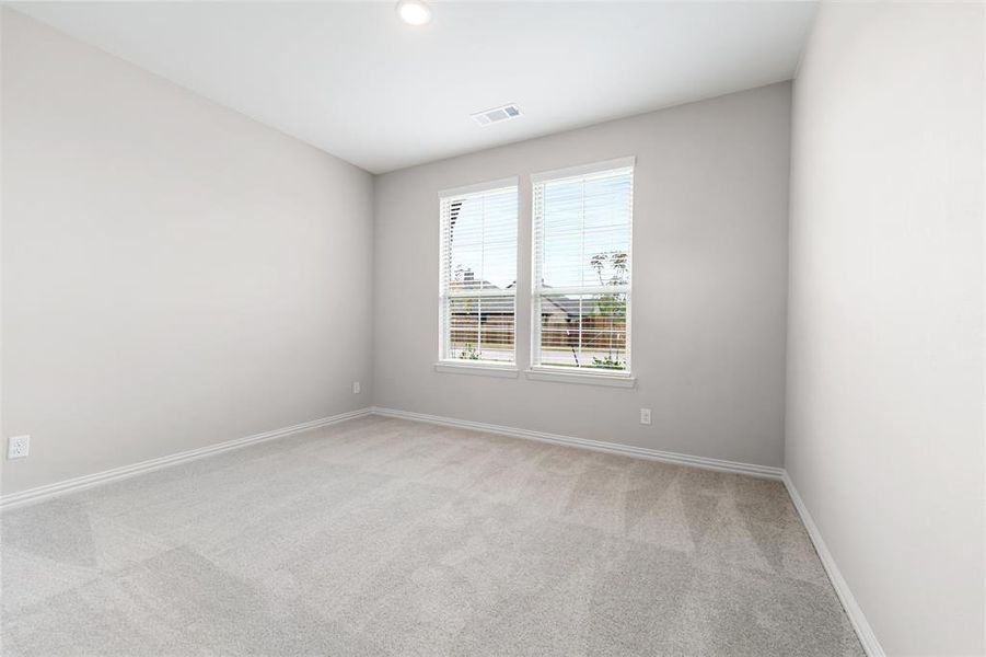Empty room with light colored carpet and recessed lighting Empty room with light colored carpet and recessed lighting