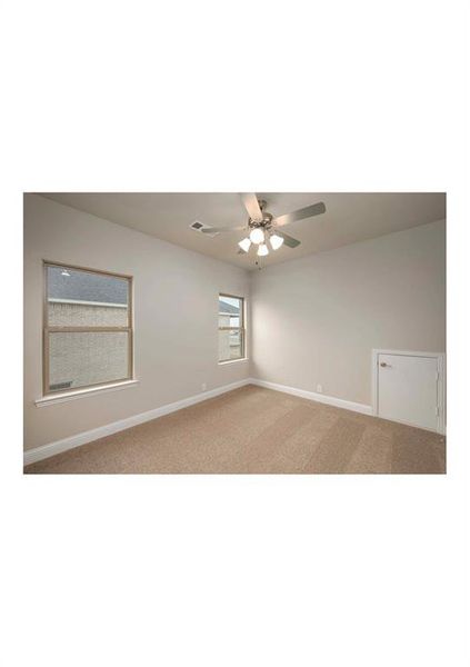 Spare room featuring ceiling fan and light carpet