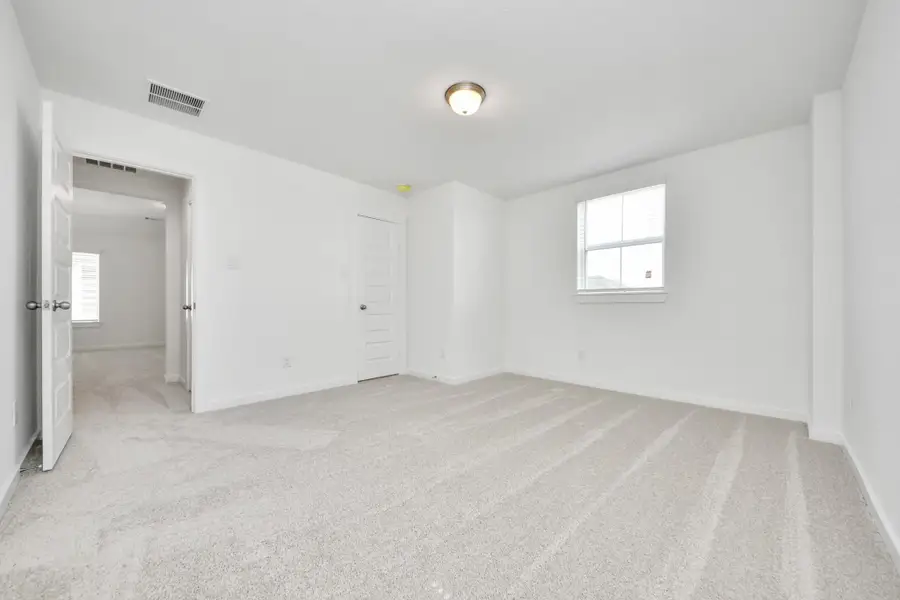 Generously sized secondary bedrooms featuring spacious closets, soft and inviting carpeting underfoot, large windows allowing plenty of natural light, and the added touch of privacy blinds for your personal retreat.