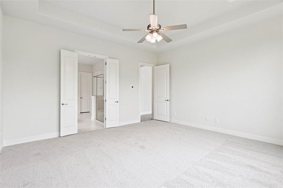 Unfurnished bedroom with light carpet and ceiling fan