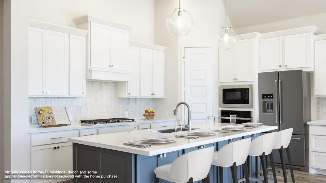 Kitchen featuring tasteful backsplash, stainless steel appliances, white cabinetry, pendant lighting, and a center island with sink Kitchen featuring tasteful backsplash, stainless steel appliances, white cabinetry, pendant lighting, and a center island with sink