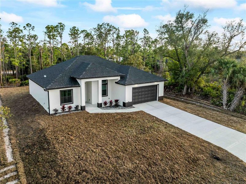 Front exterior of a new home in , Port Charlotte, FL, highlighting curb appeal (Image 26).